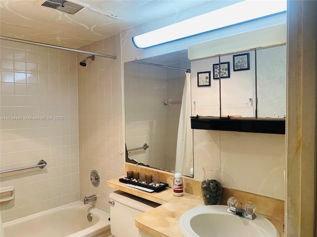 full bathroom featuring vanity, shower / tub combo with curtain, and toilet