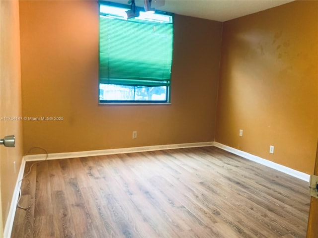 unfurnished room with hardwood / wood-style floors