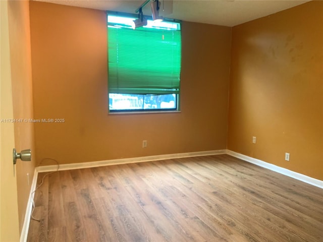 empty room featuring hardwood / wood-style floors and a healthy amount of sunlight