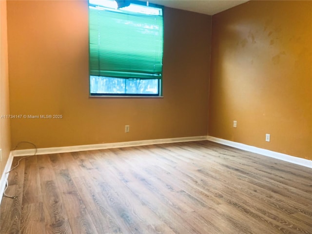 spare room with wood-type flooring