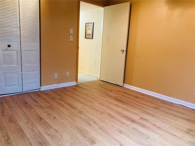 unfurnished bedroom with a closet and light hardwood / wood-style flooring