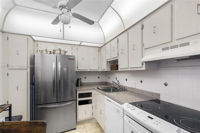 kitchen with white cabinetry, white appliances, sink, and light tile patterned floors