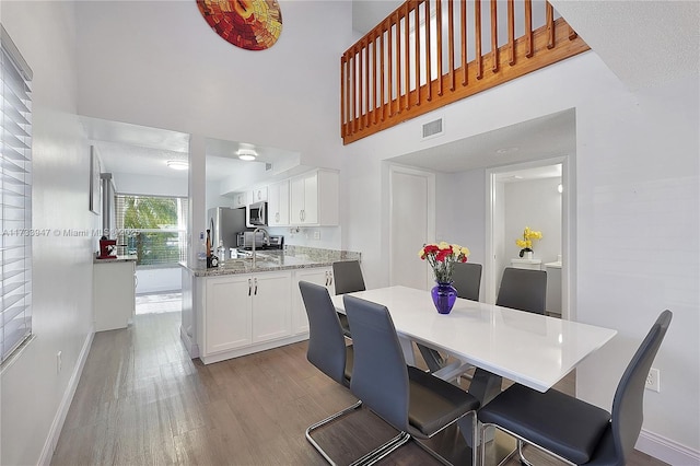 dining space featuring light wood-type flooring