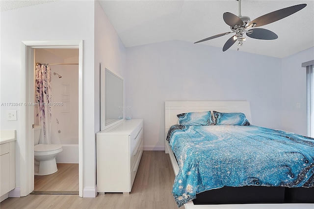 bedroom with light hardwood / wood-style floors, ceiling fan, and ensuite bathroom