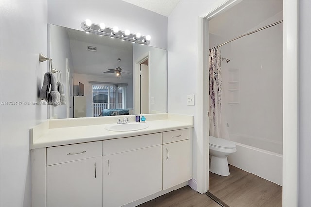 full bathroom with wood-type flooring, shower / bath combination with curtain, vanity, ceiling fan, and toilet