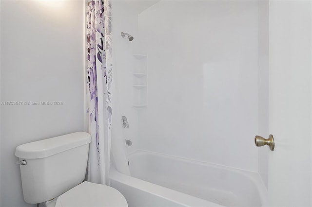 bathroom with shower / tub combo with curtain and toilet