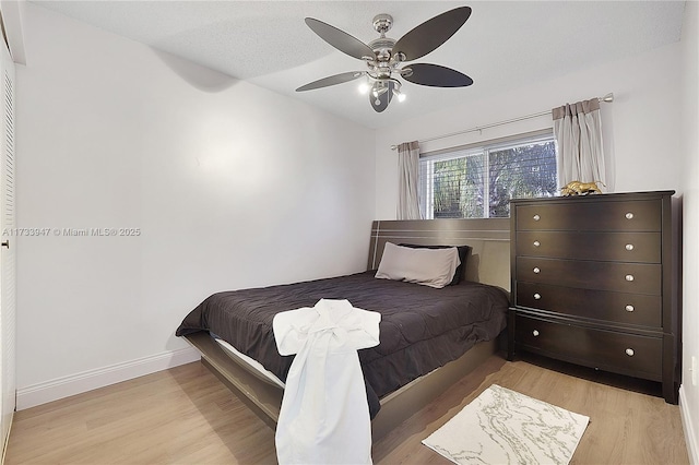 bedroom with ceiling fan and light wood-type flooring