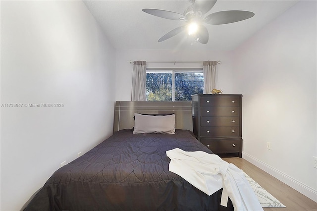 bedroom featuring ceiling fan and wood-type flooring