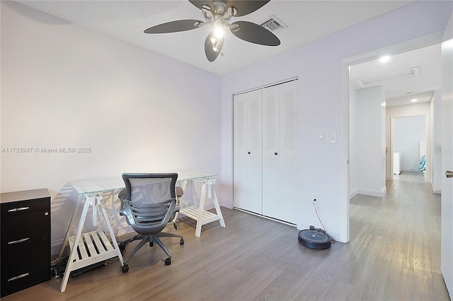 office space with light hardwood / wood-style flooring and ceiling fan