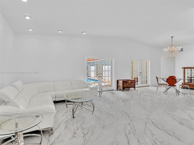 living room with vaulted ceiling, french doors, and a chandelier