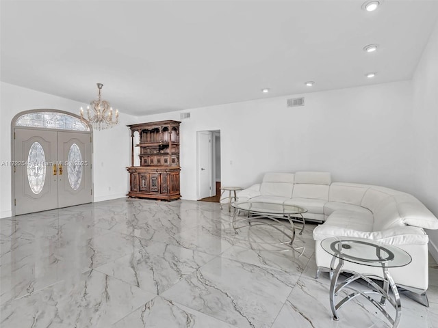 unfurnished living room with french doors and a notable chandelier