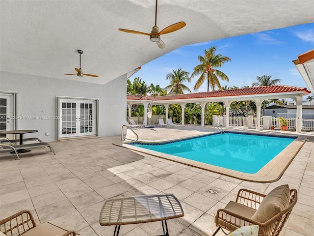 view of swimming pool with a patio area, french doors, and ceiling fan