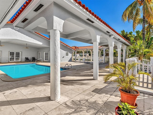 view of swimming pool with a patio, french doors, and ceiling fan