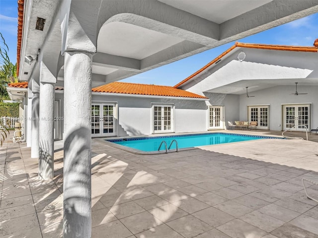 view of pool featuring a patio, french doors, and ceiling fan