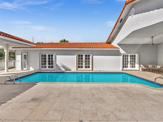 view of swimming pool featuring french doors and a patio