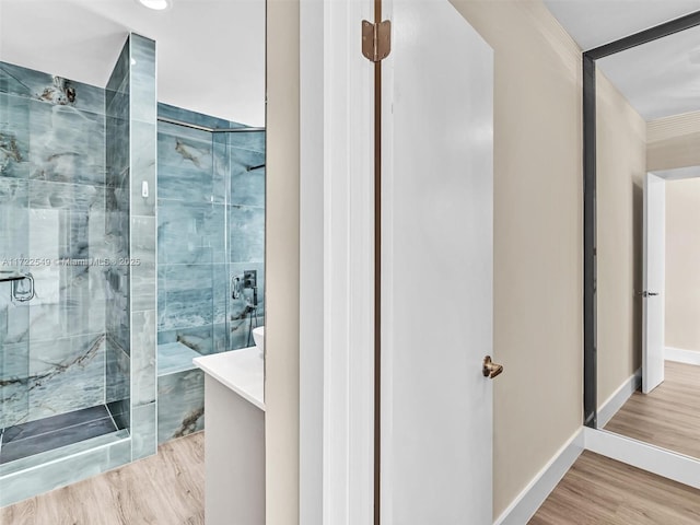 bathroom featuring wood-type flooring and an enclosed shower