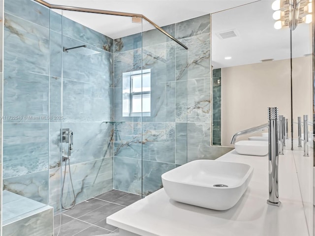 12904 Banyan Rd, North Miami, FL 33181 - bathroom featuring a marble finish shower, tile walls, double vanity, and tile patterned floors