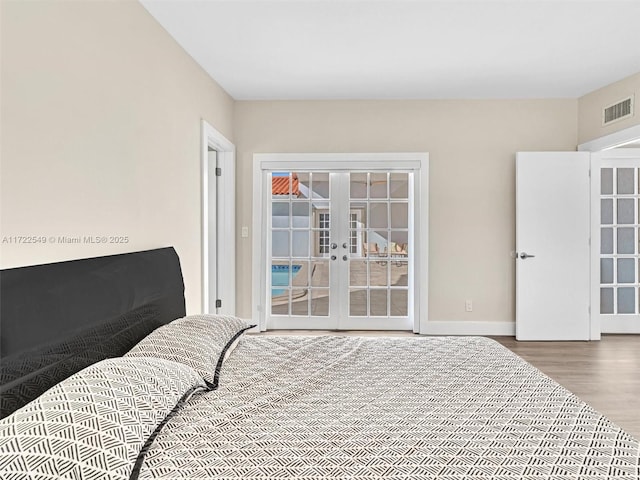 12904 Banyan Rd, North Miami, FL 33181 - bedroom featuring french doors, wood finished floors, baseboards, and access to exterior