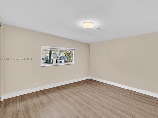 spare room with light hardwood / wood-style flooring