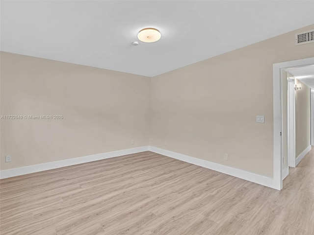 unfurnished room with light wood-type flooring