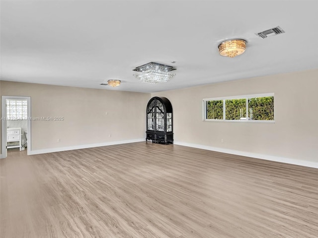 unfurnished living room featuring a healthy amount of sunlight and light hardwood / wood-style floors