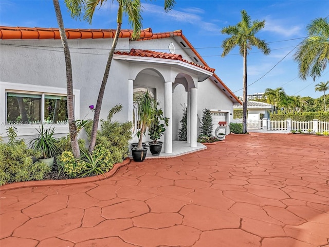 12904 Banyan Rd, North Miami, FL 33181 - view of patio with an attached garage and driveway