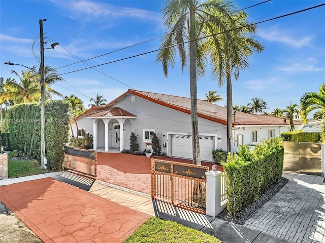 mediterranean / spanish-style home featuring a garage