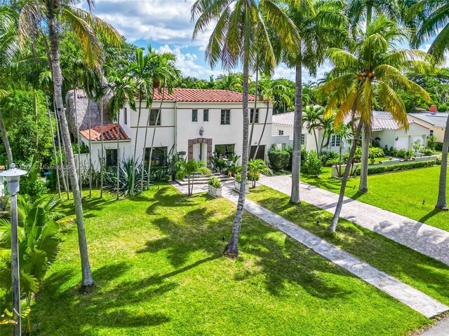 back of property featuring a yard and a deck