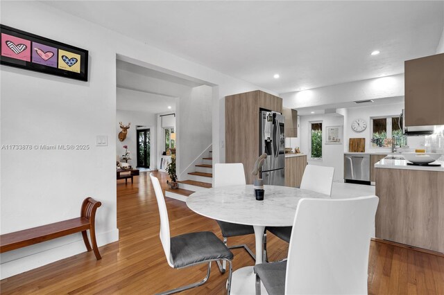 dining space with light hardwood / wood-style floors