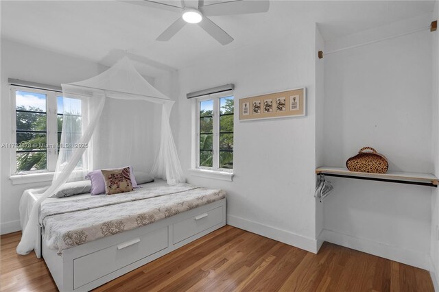 bedroom with ceiling fan and light hardwood / wood-style floors