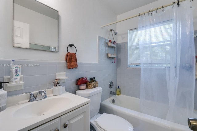 full bathroom featuring vanity, tile walls, shower / tub combo, and toilet