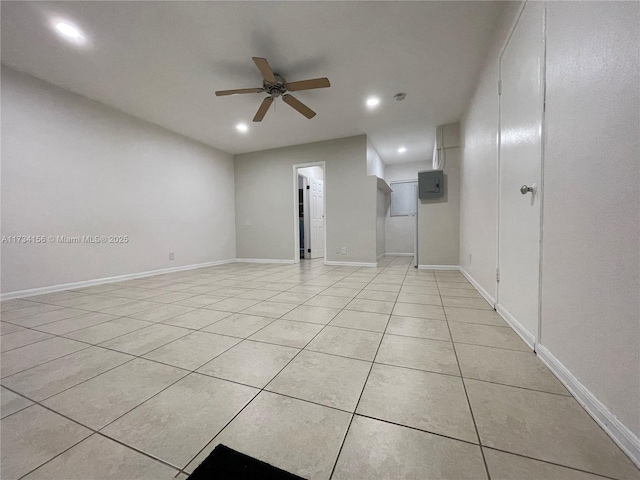 tiled spare room with electric panel and ceiling fan