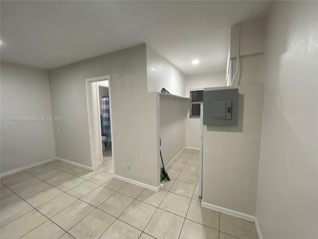 tiled spare room featuring electric panel