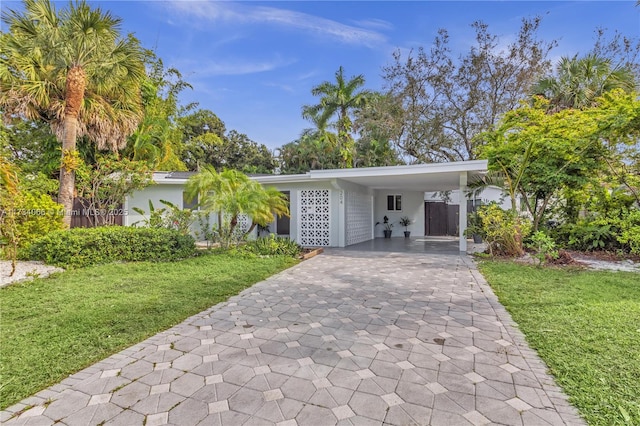 ranch-style house with a front lawn and a carport