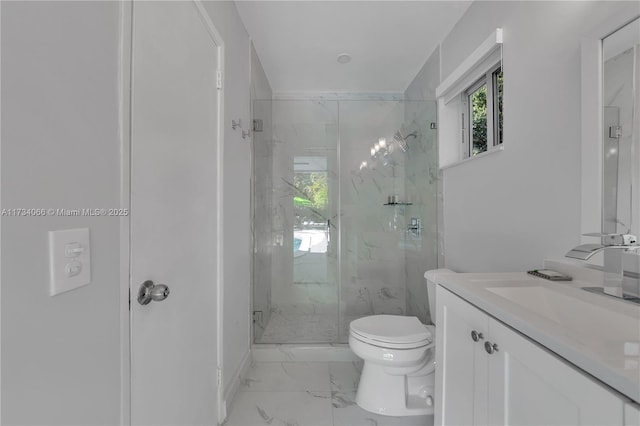 bathroom featuring vanity, toilet, and a shower with door