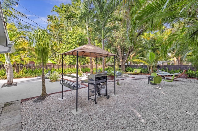 view of property's community with a gazebo and a patio