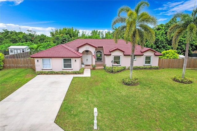 mediterranean / spanish house with a front yard