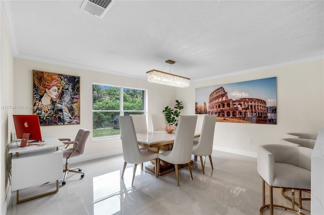 dining area with ornamental molding, a textured ceiling, and a notable chandelier