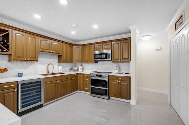 kitchen featuring wine cooler, sink, crown molding, light tile patterned floors, and stainless steel appliances