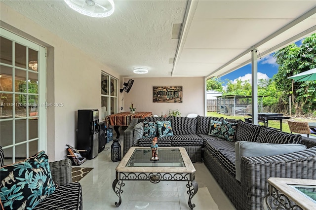 living room featuring light tile patterned floors and a textured ceiling