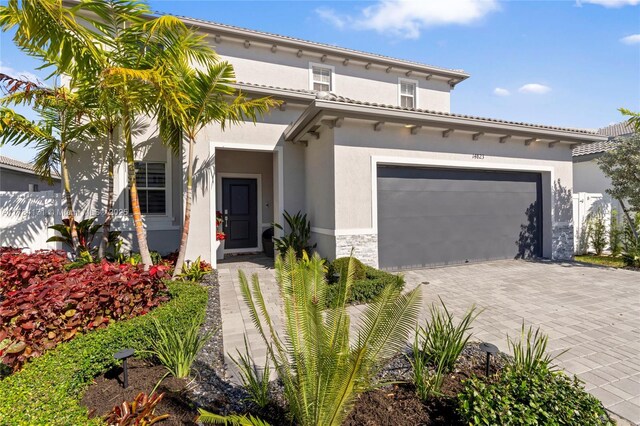 14823 SW 163rd Ter, Miami, FL 33187 - mediterranean / spanish-style home with stucco siding, decorative driveway, and a garage