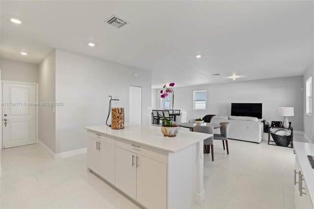 14823 SW 163rd Ter, Miami, FL 33187 - kitchen featuring a kitchen island, white cabinets, recessed lighting, light countertops, and baseboards