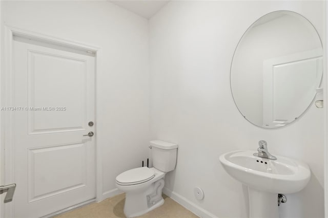 bathroom with sink, tile patterned floors, and toilet