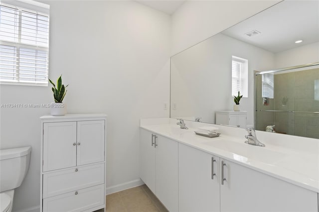 bathroom featuring an enclosed shower, vanity, tile patterned flooring, and toilet