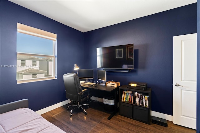 home office with dark hardwood / wood-style flooring