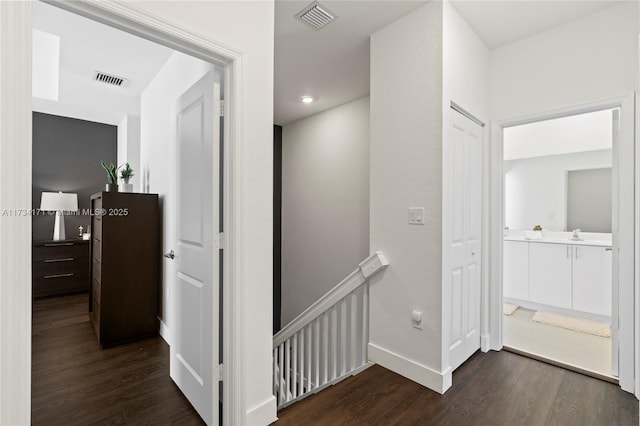 corridor with dark hardwood / wood-style floors