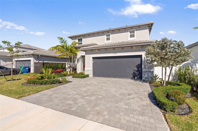 14823 SW 163rd Ter, Miami, FL 33187 - mediterranean / spanish home with stucco siding, decorative driveway, a garage, and stone siding