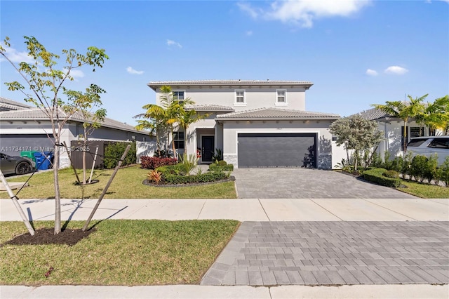 14823 SW 163rd Ter, Miami, FL 33187 - mediterranean / spanish home with stucco siding, decorative driveway, a garage, a front lawn, and a tiled roof