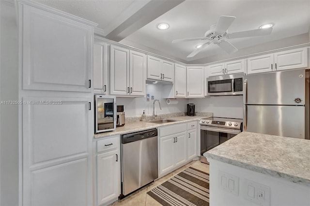 kitchen featuring light tile patterned floors, stainless steel appliances, sink, and white cabinets