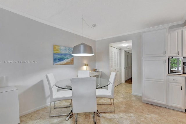 dining room featuring light tile patterned floors and ornamental molding